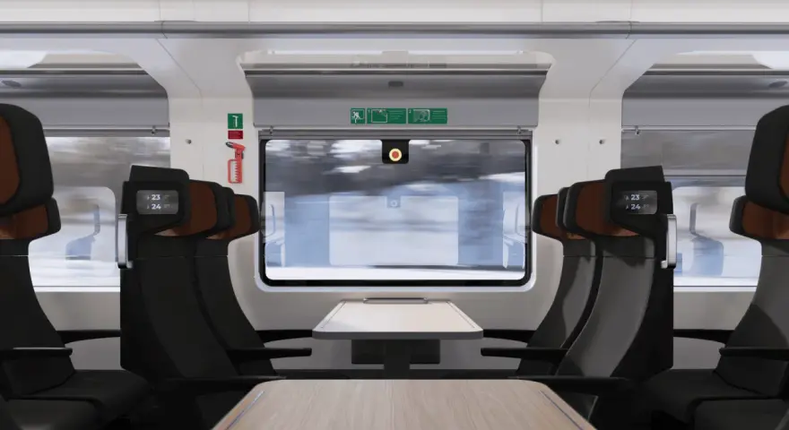 Interiör i ett modernt tåg med bekväma säten och fällbara bord. Nya nattåg erbjuder en bekväm resa genom det snöiga landskapet.